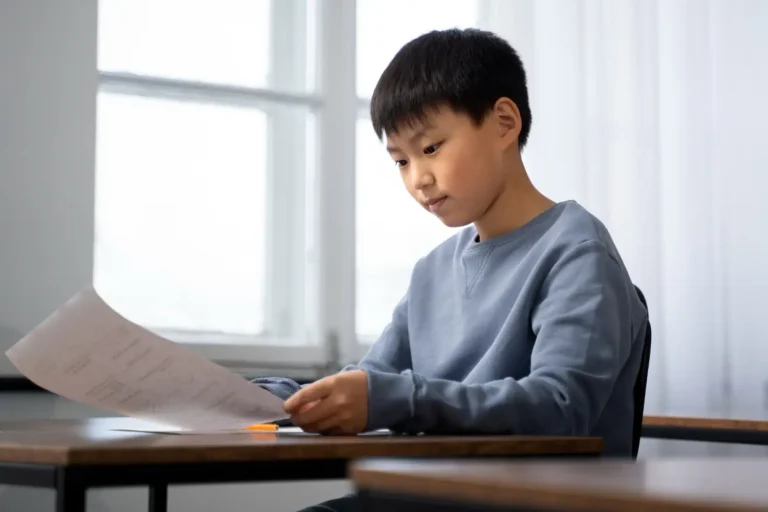 Homeschool student filling out a paper standardized test booklet to mail in for scoring